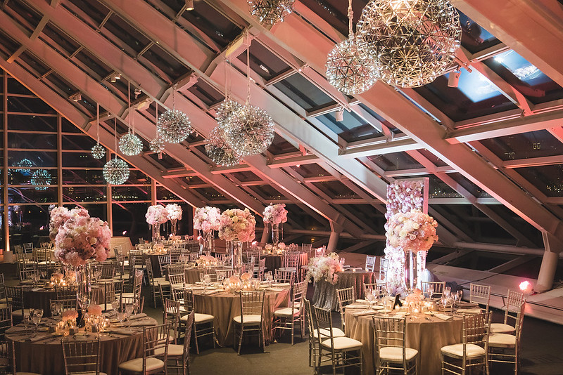 Chairs And Tables With Flowers On Top And Sphere Chandeliers Hanging At Adler Planetarium Solarium