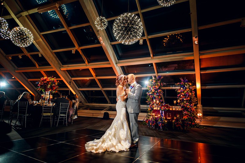 Bride And Groom Dance Under The Elegant Chandeliers At Their Adler Planetarium Wedding