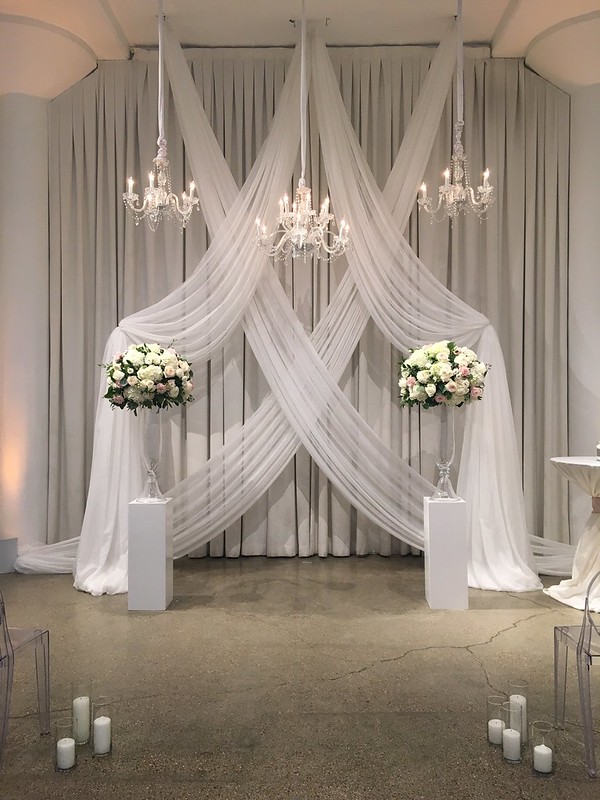 Wedding Chandeliers As A Backdrop With Drape Wall