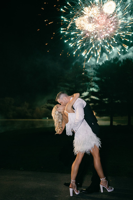 Bride And Groom Share Tender Kiss With Dazzling Fireworks In Background At The Clubhouse Wedding