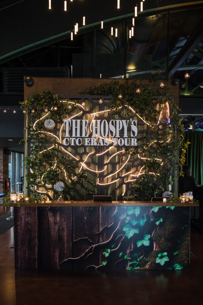 Bar Statement Spelling Out &Quot;The Hospys Ctc Eras Tour&Quot; With Lighting And Greenery