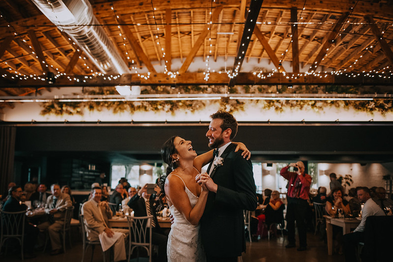 Bride And Groom Dancing Under The String Lights