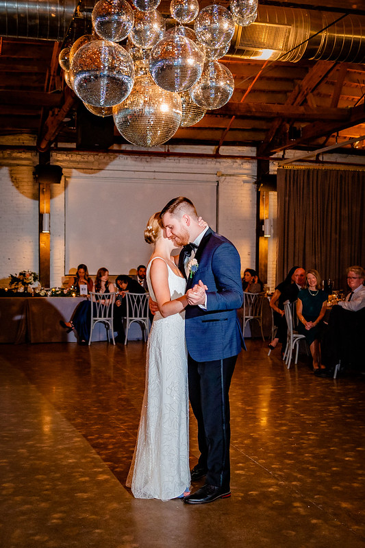 Bride And Groom Dance Under The Clustered Mirror Balls