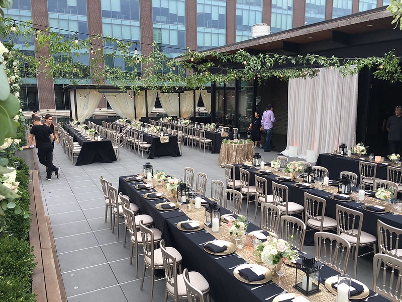 Rooftop Venue, With String Lights And Greenery