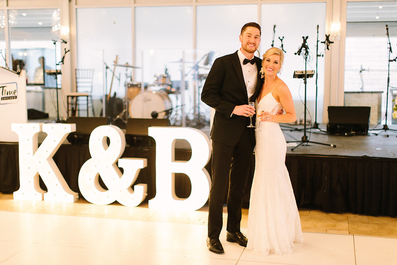 Groom And Bride With Marquee Letters Spelled Their Name Initials