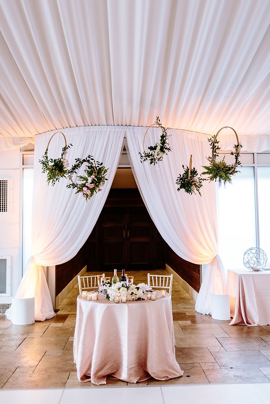 White Entry Drape With Uplighting. White Table And Chairs