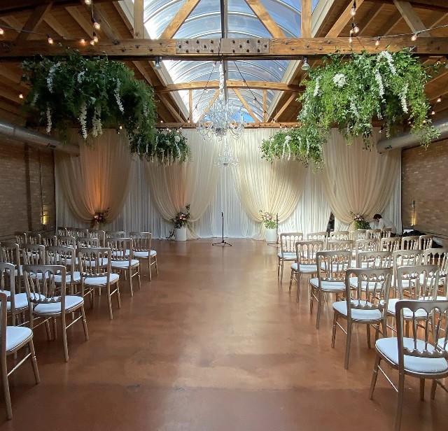 Wedding Loft Venue With White Drape Wall And Hanging Greenery