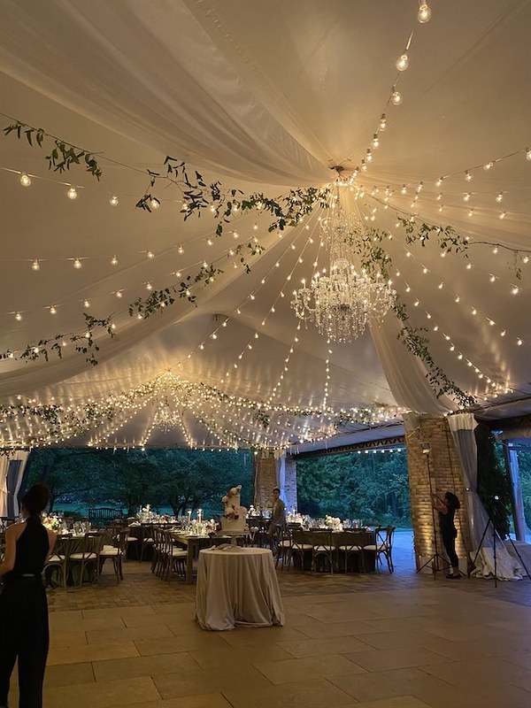 Tent With String Lights And Greenery And Crystal Chandelier