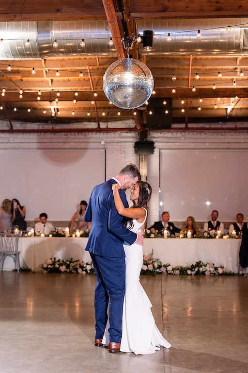 Bride And Groom Dancing Under The Mirror Ball And Romantic String Lights