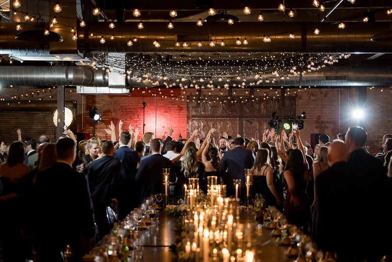 Wedding Guests Celebrating Under Twinkle Lights And String Lights