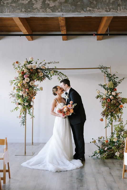 Groom Kissed The Bride, Florals As Their Backdrop