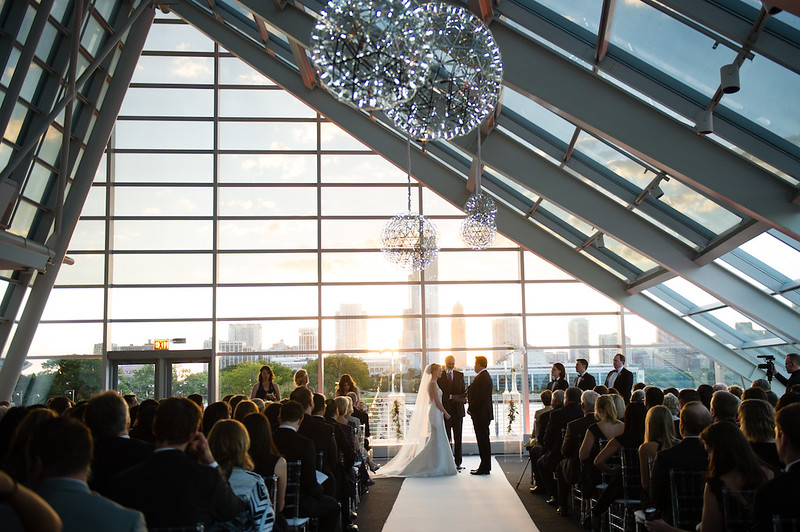 Bride And Groom At Their Wedding Ceremony At Alder Planetarium. Silver Pendant Chandeliers Hanging Above