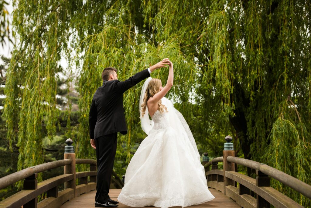Bride And Groom Dancing In The Wooden Bridge