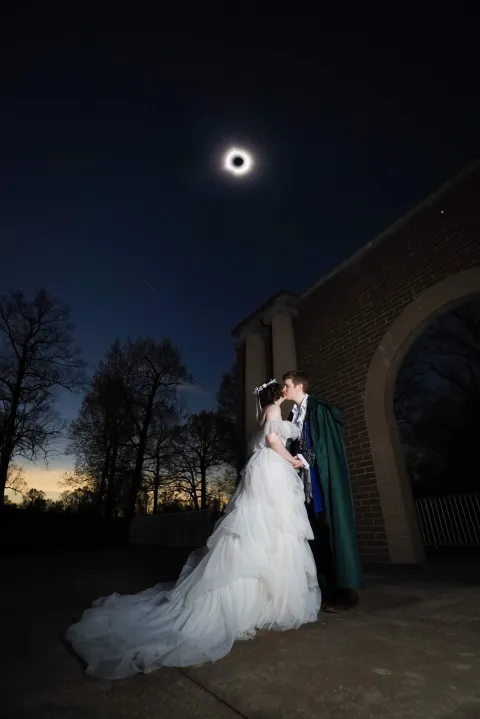 Bride And Groom Under The Eclipse Sky