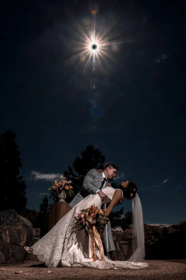 Bride And Groom Under The Eclipse Sky