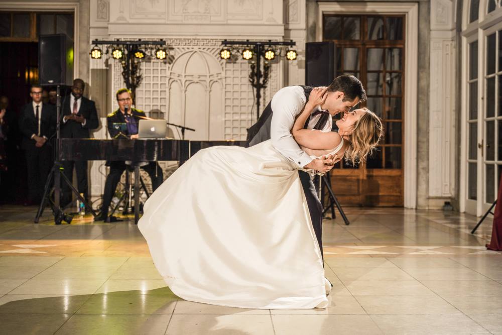 Bride And Groom Dancing While Dueling Pianists Play A Piano