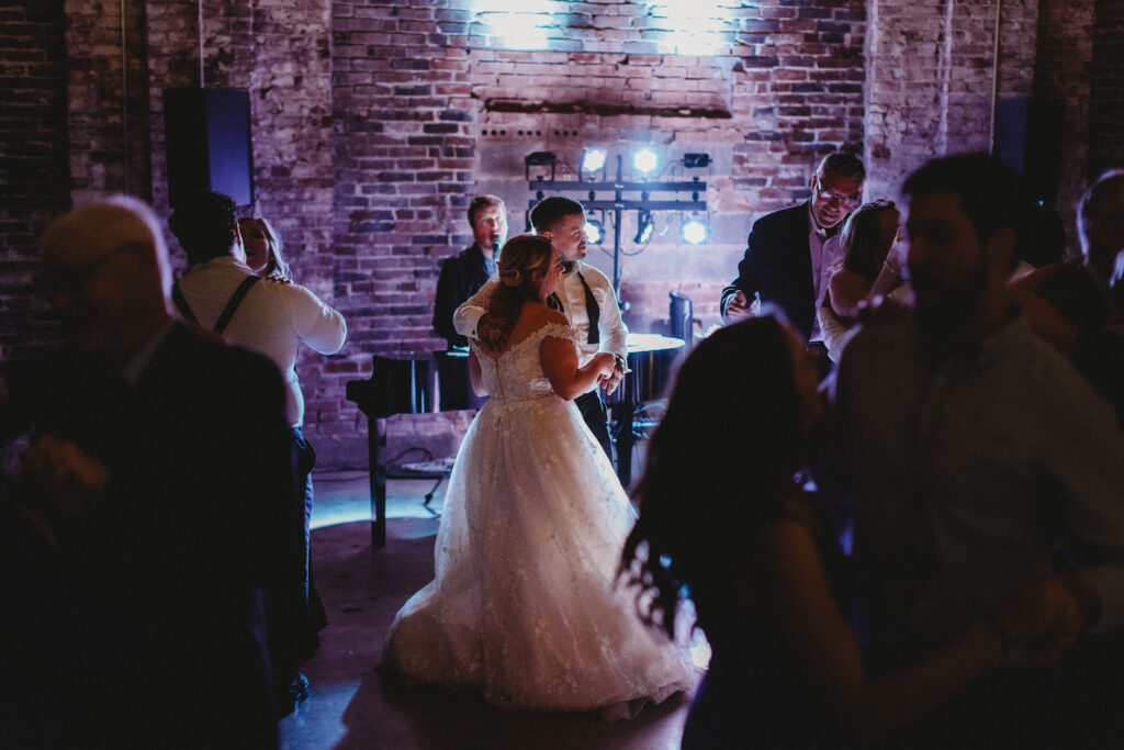 Bride And Groom Dancing While Dueling Pianists Play A Piano