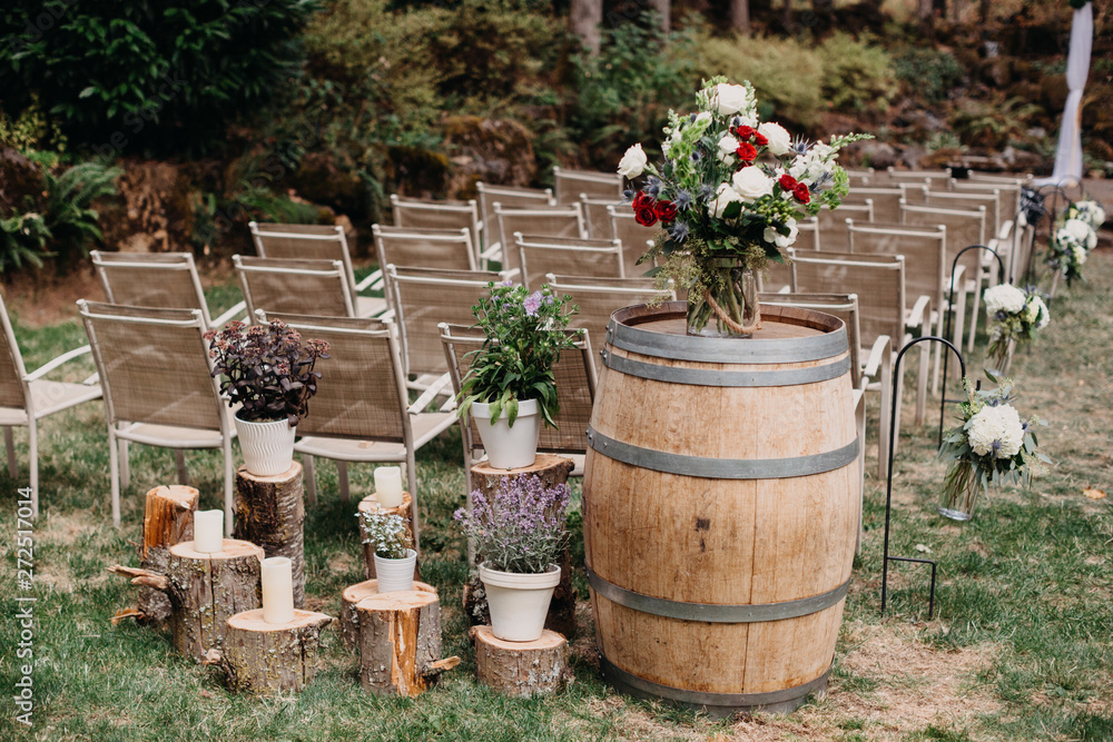 Whiskey Barrel As Flower Stand In A Outside Wedding Ceremony