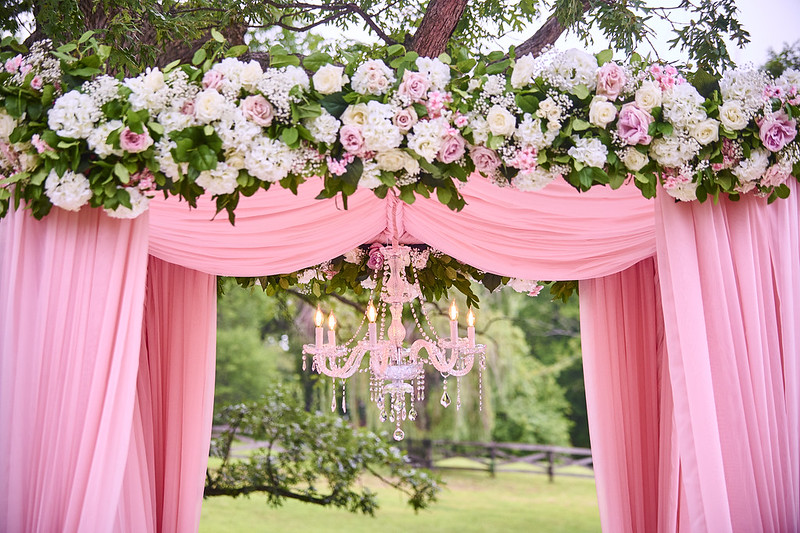 Draped Wedding Canopy With Floral Decors And Chandeliers