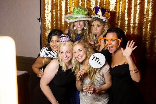 Guests Happily Take Their Photos In The Wedding Photo Booth