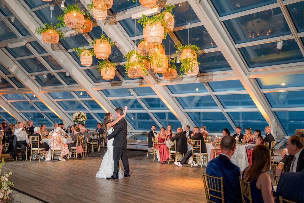 Bride And Groom Dancing Under The Rattan Lanterns At The Reception