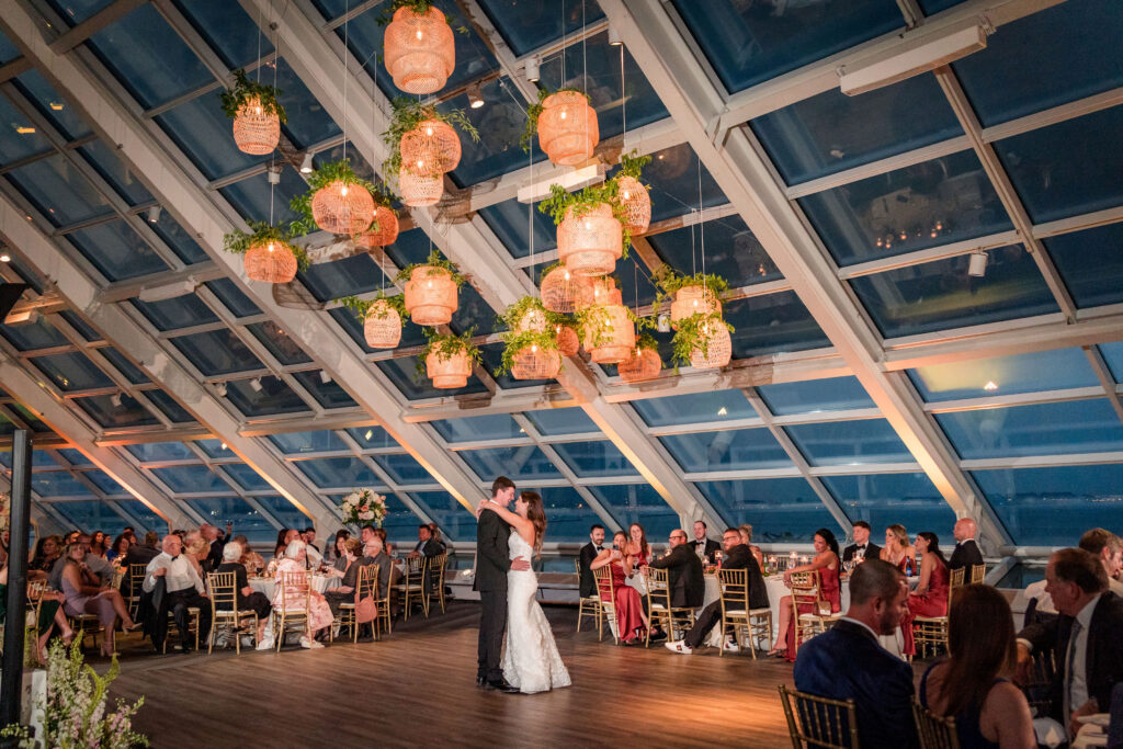 Bride And Groom Dancing Under The Rattan Lanterns At The Reception