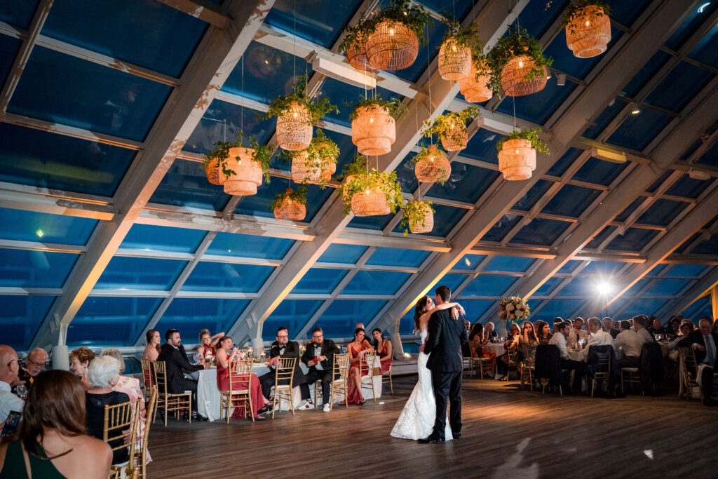 Bride And Groom Dancing Under The Rattan Lanterns At The Reception