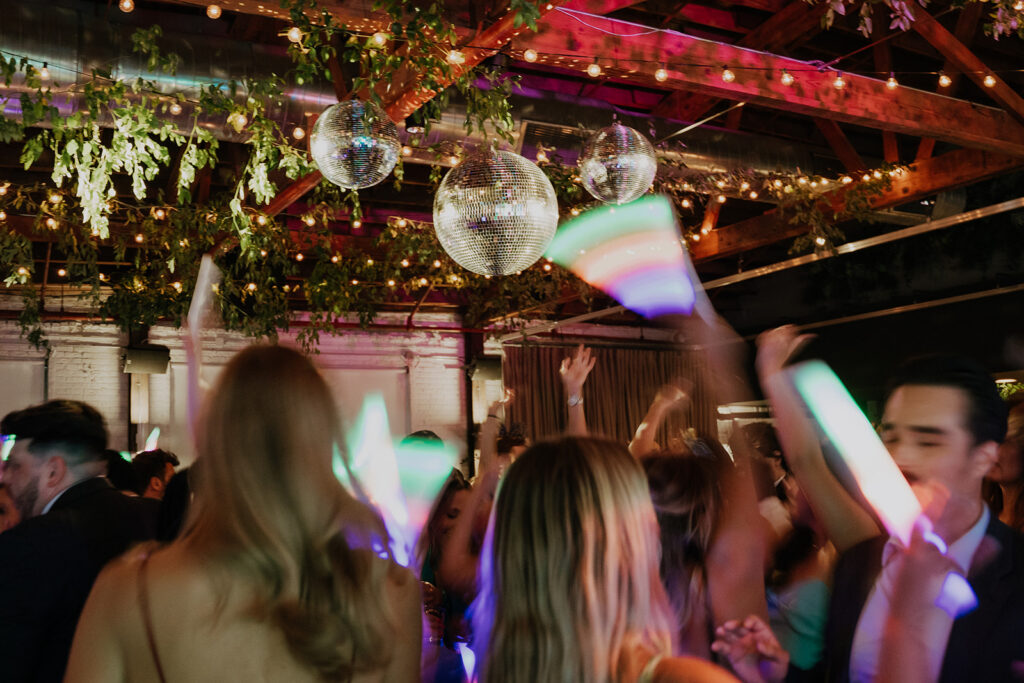 Guests Dancing Under The Mirror Balls And String Lights