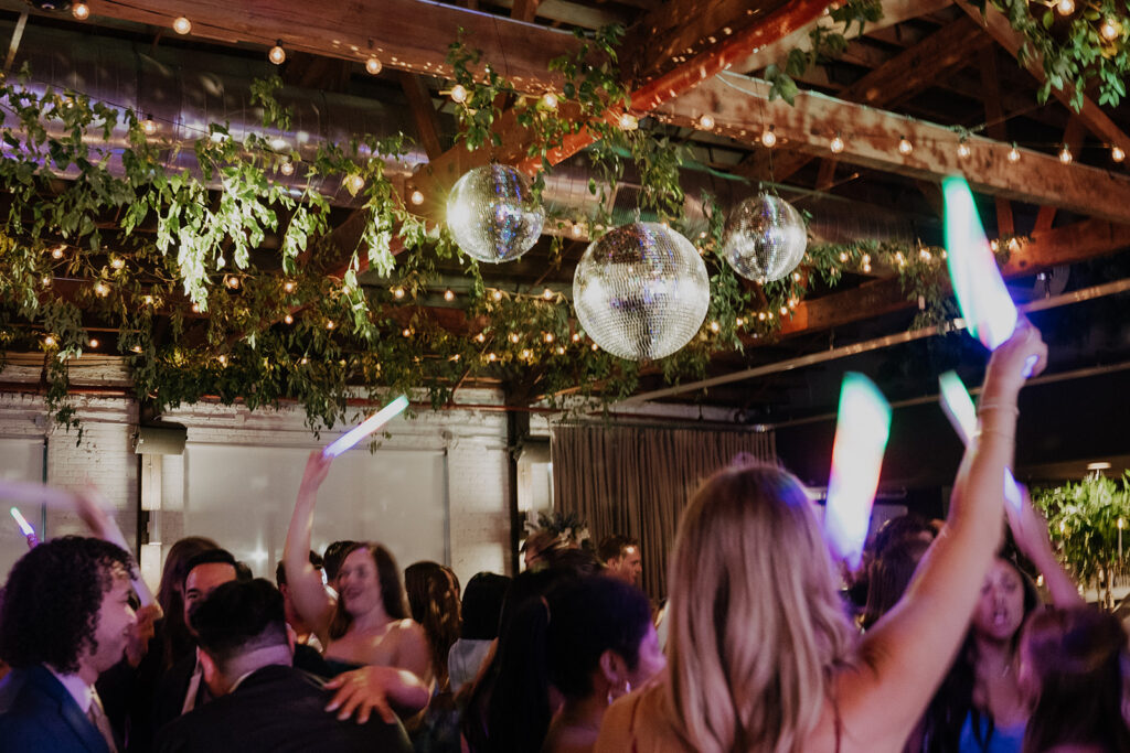 Guests Dancing Under The Mirror Balls And String Lights