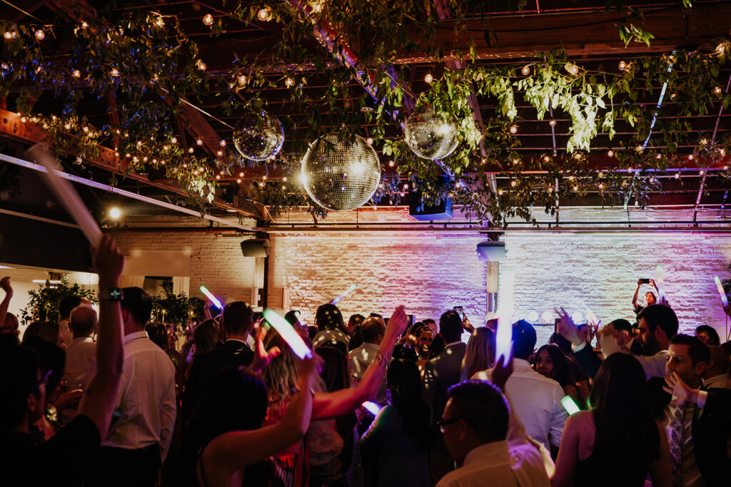Guests Dancing Under The Mirror Balls And String Lights