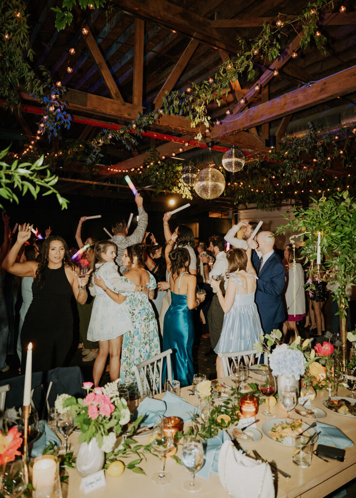 Guests Dancing Under The Mirror Balls And String Lights