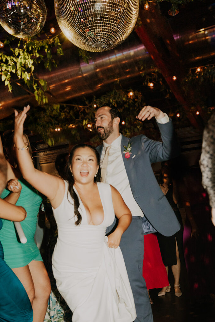 Guests Dancing Under The Mirror Balls And String Lights