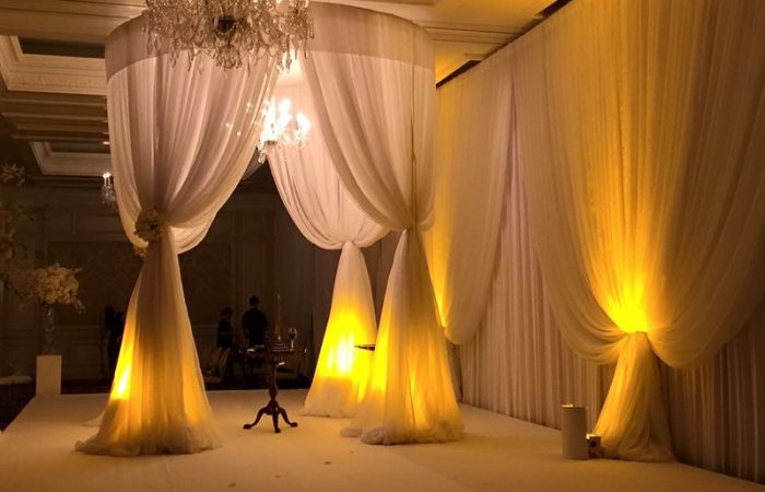 White Draped Wedding Canopy With Uplighting And Chandelier