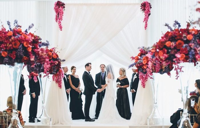 Bride And Groom At Their Wedding Ceremony With Wedding Canopy / Structure.