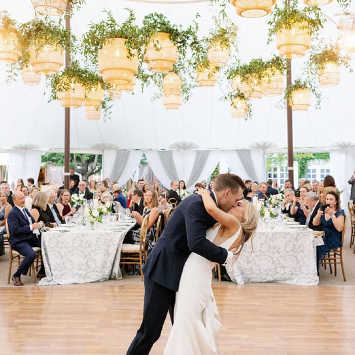 Bride And Groom Kissing On The Dancefloor, Rattan Lantern Wedding Decor Above Them