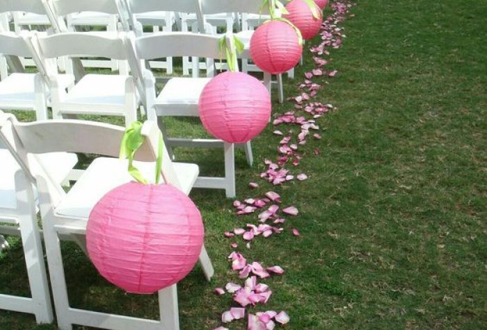 Pink Paper Lanterns Hanging On The Chairs At The Wedding Ceremony